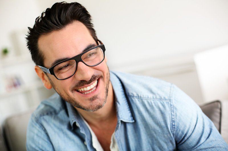 man in glasses smiling